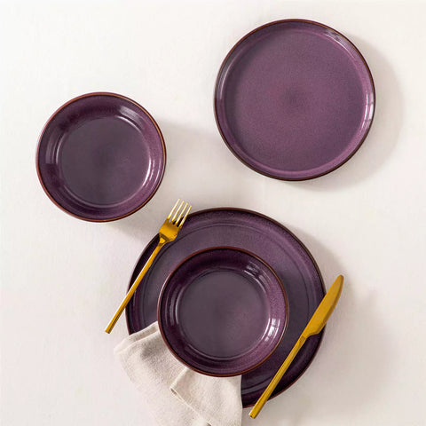Sata purple stoneware 12 piece dinnerware set with dinner plates salad plates and cereal bowls styled with gold cutlery on textured surface farmhouse reactive glaze lipped edge service for 4
