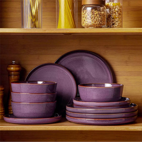 Sata purple stoneware 12 piece dinnerware set with dinner plates salad plates and cereal bowls styled with gold cutlery on textured surface farmhouse reactive glaze lipped edge service for 4