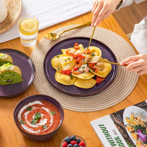 Sata purple stoneware 18 piece dinnerware set with dinner plates salad plates and cereal bowls styled on a wooden table with diverse meal setup farmhouse reactive glaze lipped edge service for 6