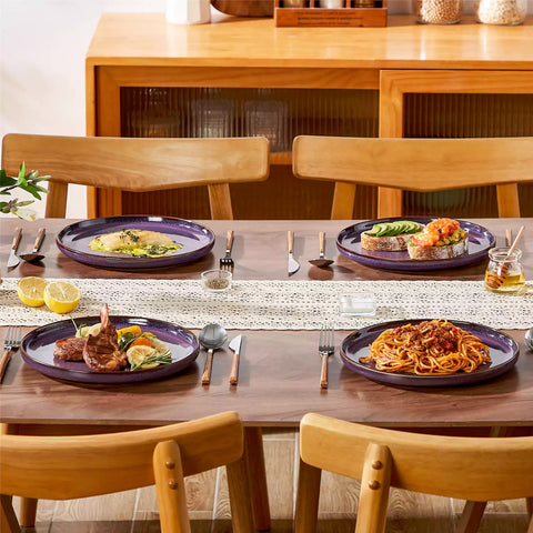 Sata purple stoneware dinner plate set of 4 styled with lamb chops and vegetables on a dinner table farmhouse lipped edge reactive glaze one of a kind finish