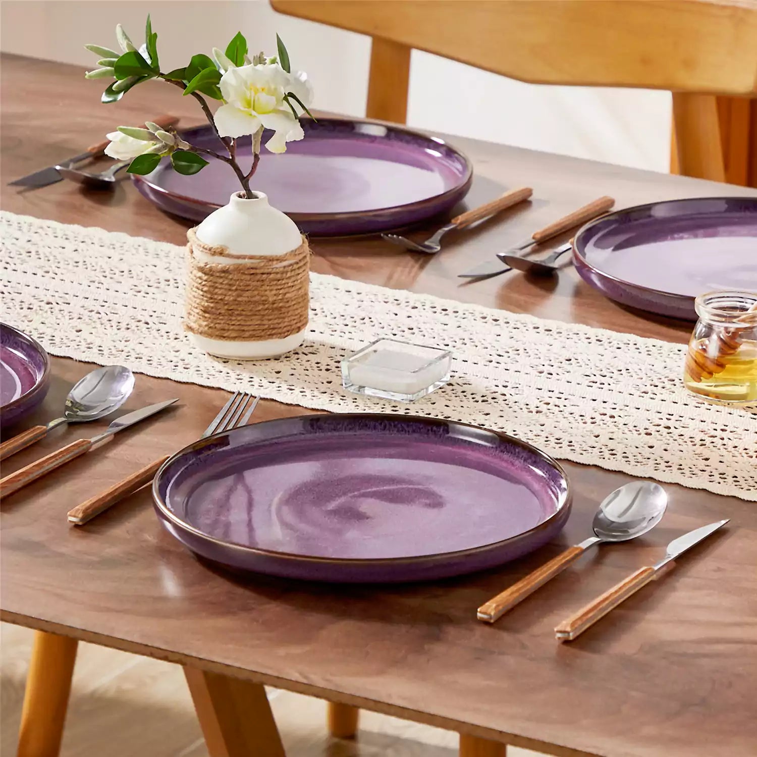 Sata purple stoneware dinner plate set of 4 styled with lamb chops and vegetables on a dinner table farmhouse lipped edge reactive glaze one of a kind finish
