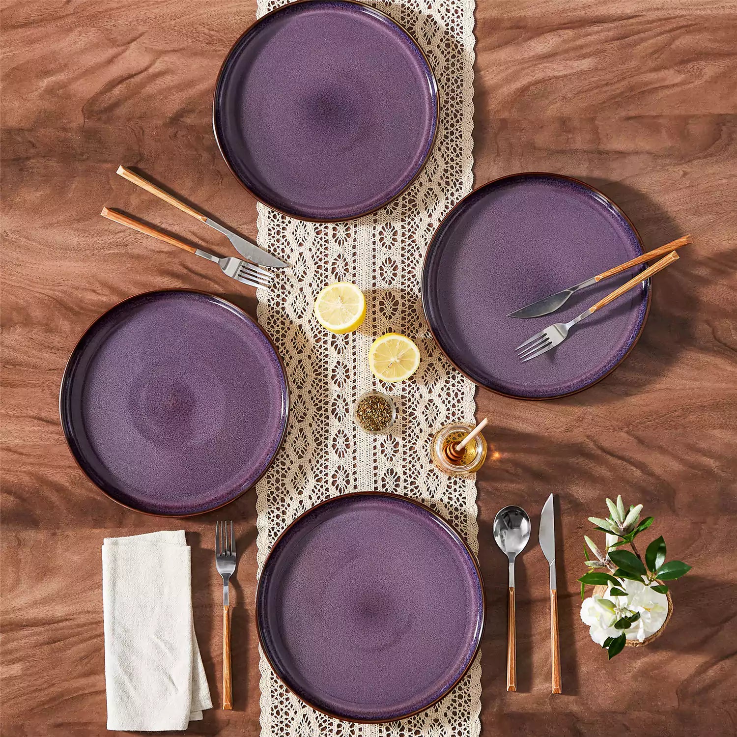 Sata purple stoneware dinner plate set of 4 styled with lamb chops and vegetables on a dinner table farmhouse lipped edge reactive glaze one of a kind finish