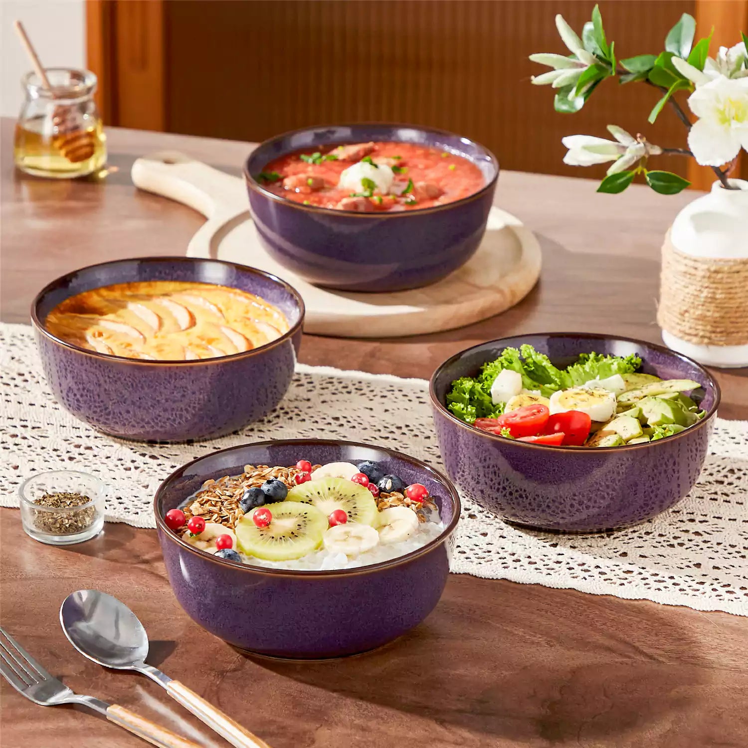 Sata purple stoneware cereal bowls set of 4 with assorted meals styled on a wooden table with lace tablecloth farmhouse reactive glaze lipped edge artisan finish