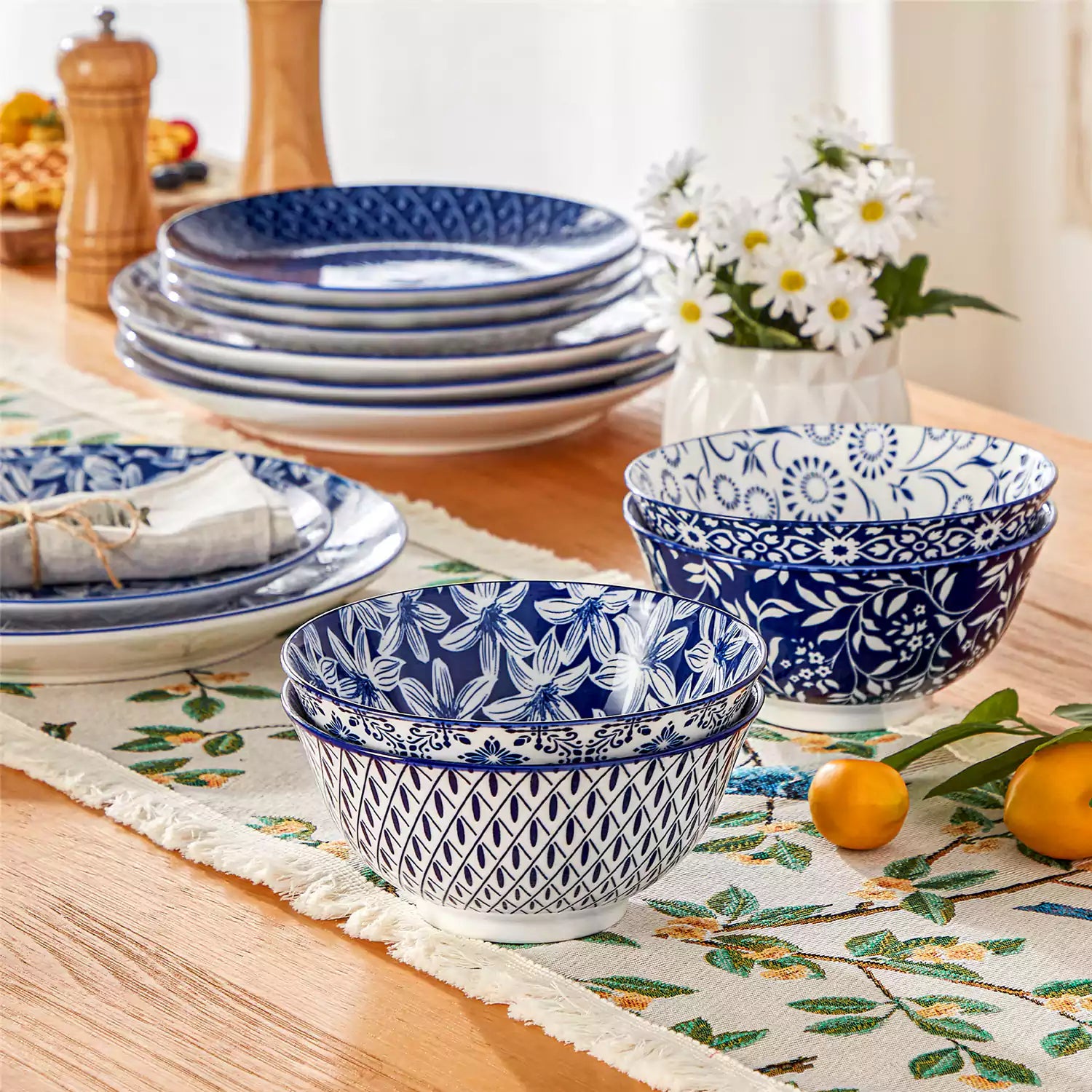 Selene porcelain cereal bowls set of 4 blue and white Japanese inspired floral pattern mix and match tableware styled with fruits and dishes on dining table