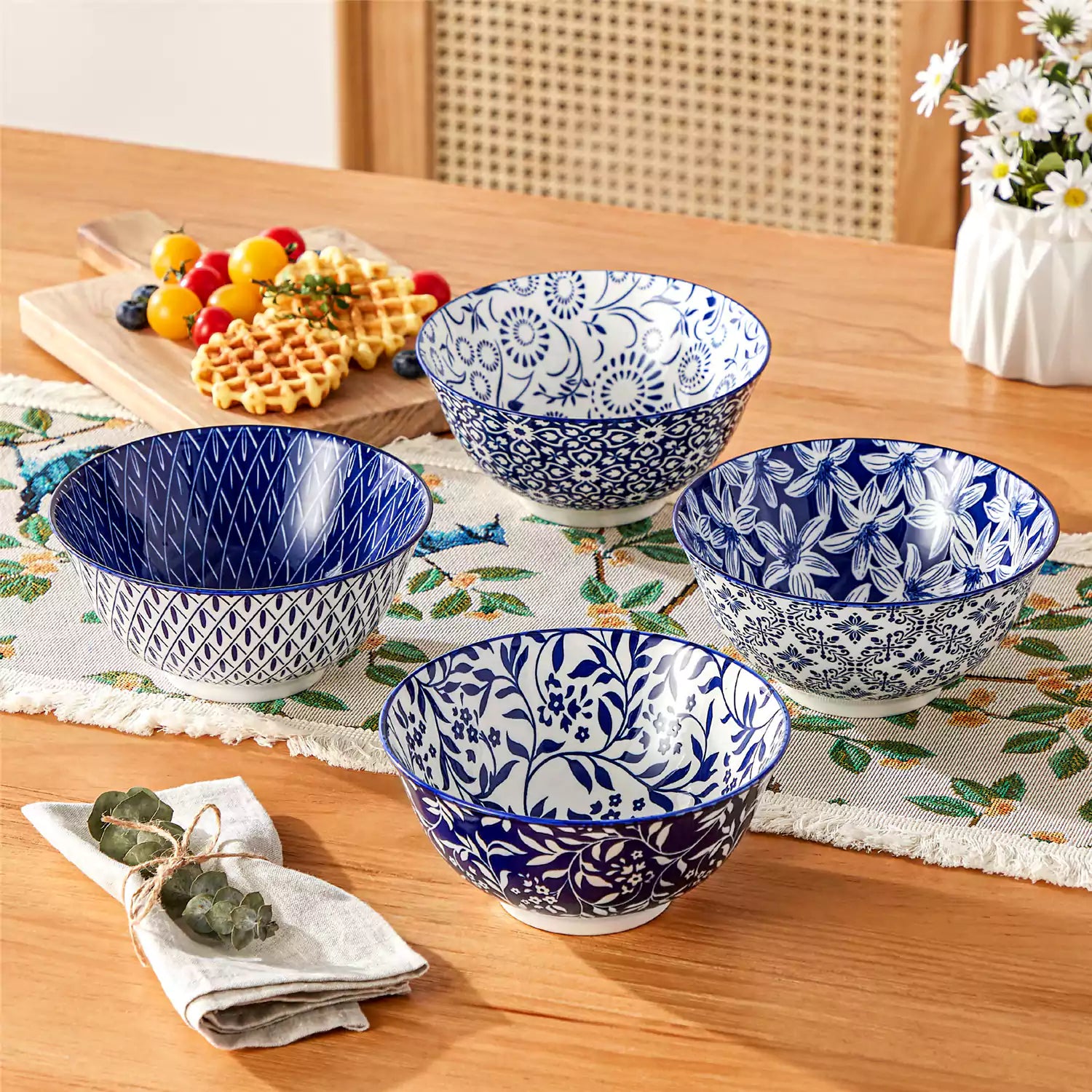 Selene porcelain cereal bowls set of 4 blue and white Japanese inspired floral pattern mix and match tableware styled with fruits and dishes on dining table