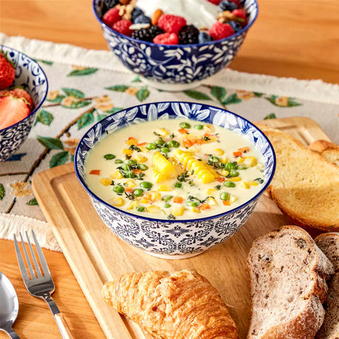 Selene porcelain cereal bowls set of 4 blue and white Japanese inspired floral pattern mix and match tableware styled with fruits and dishes on dining table