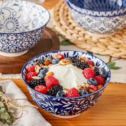 Selene porcelain cereal bowls set of 4 blue and white Japanese inspired floral pattern mix and match tableware styled with fruits and dishes on dining table
