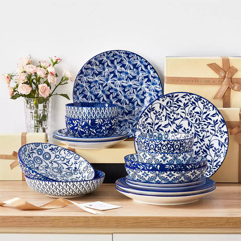 Selene 16-piece porcelain set with indigo floral and geometric patterns on plates - bowls - and mugs displayed on a dining table