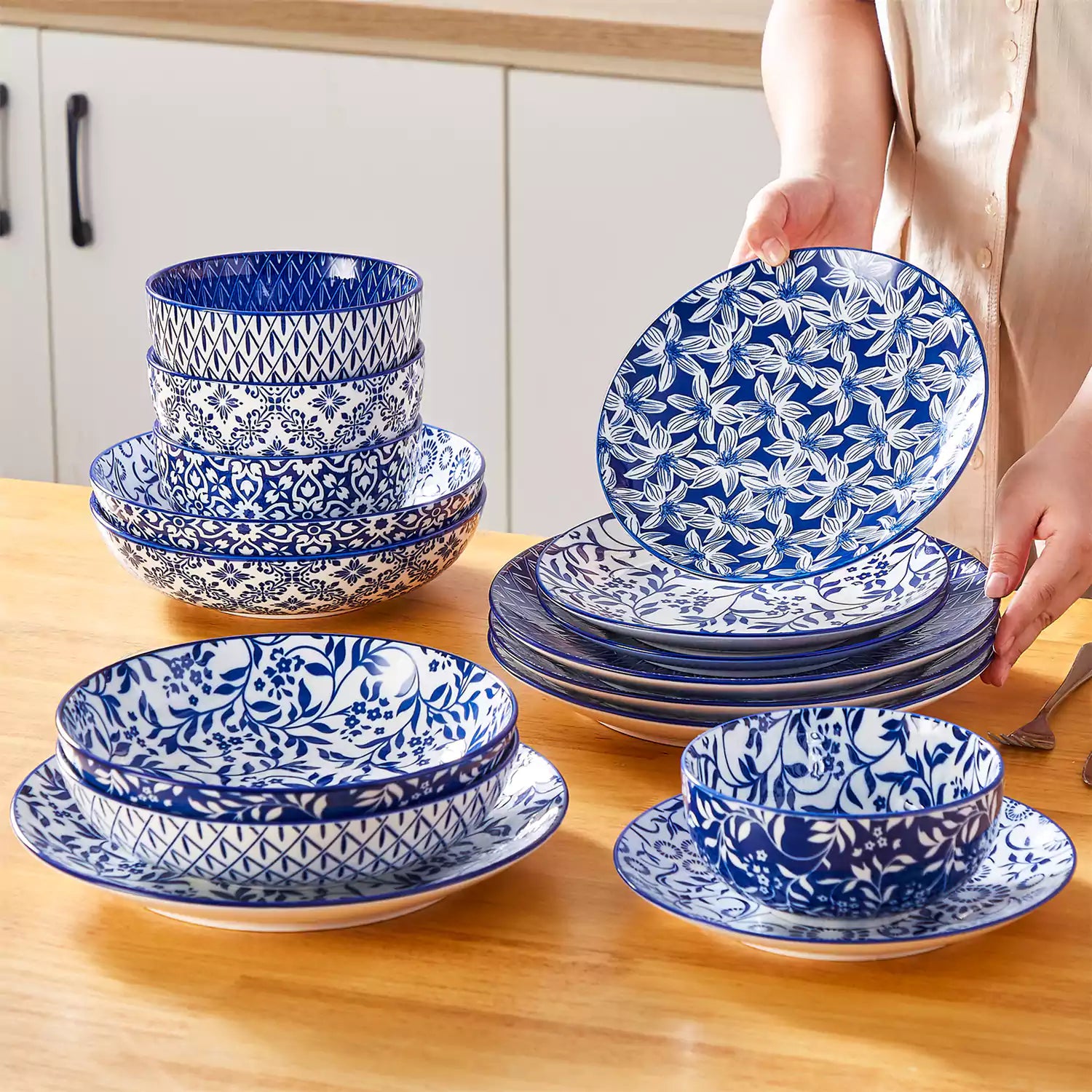 Selene 16-piece porcelain set with indigo floral and geometric patterns on plates - bowls - and mugs displayed on a dining table