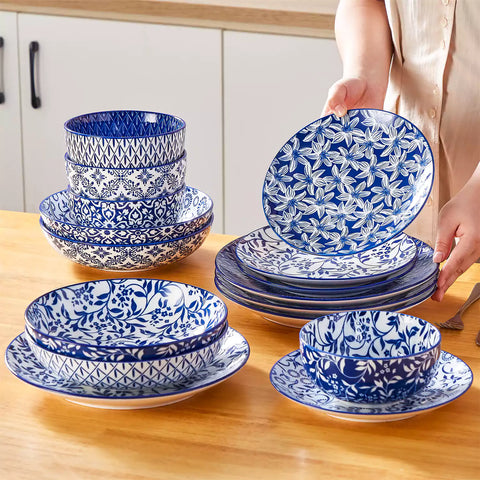Selene 16-piece porcelain set with indigo floral and geometric patterns on plates - bowls - and mugs displayed on a dining table