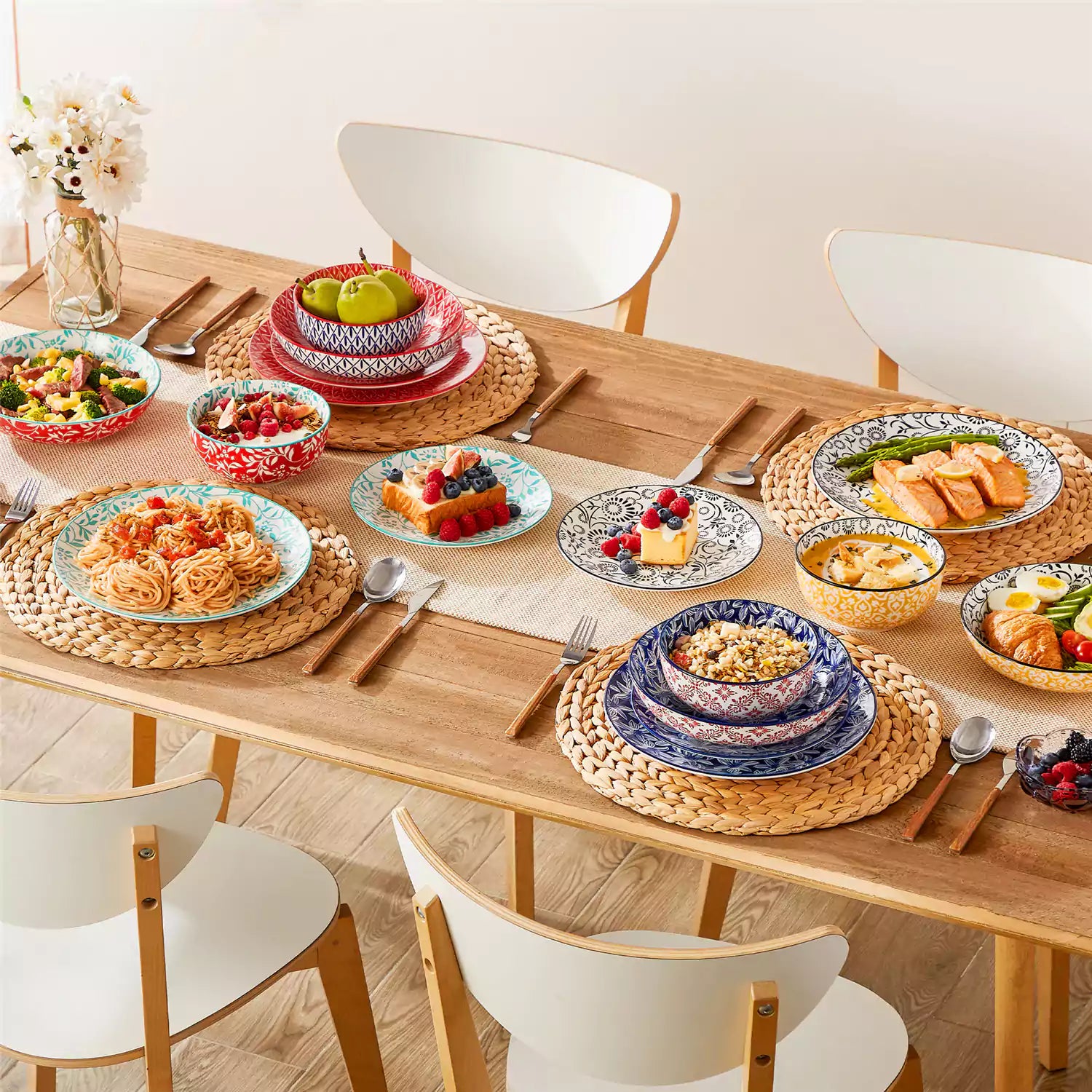 16 piece Japanese porcelain dinnerware set with indigo and earth tone floral geometric patterns on white ceramic plates and bowls