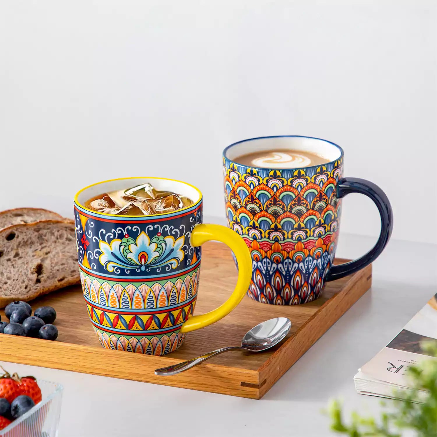 Boho-style coffee mugs filled with creamy latte, colorful porcelain set for cozy mornings