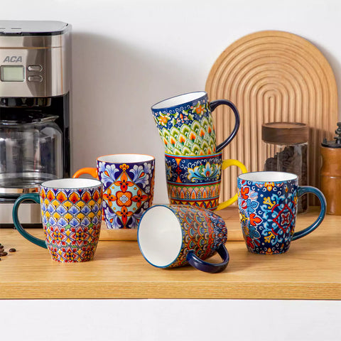 Boho-style coffee mugs filled with creamy latte, colorful porcelain set for cozy mornings