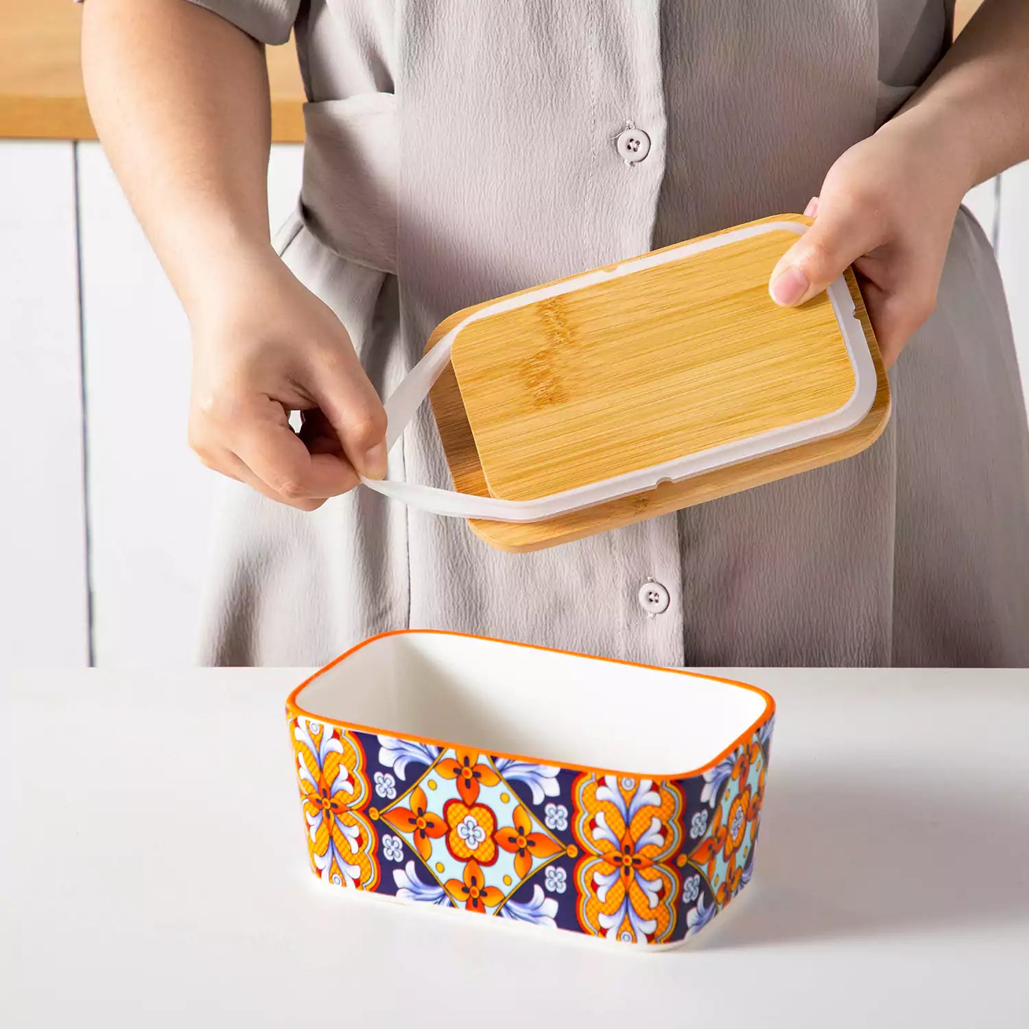 Bold orange porcelain butter dish with wooden lid in boho chic style - perfect for a colorful breakfast table with bread and coffee-vancasso
