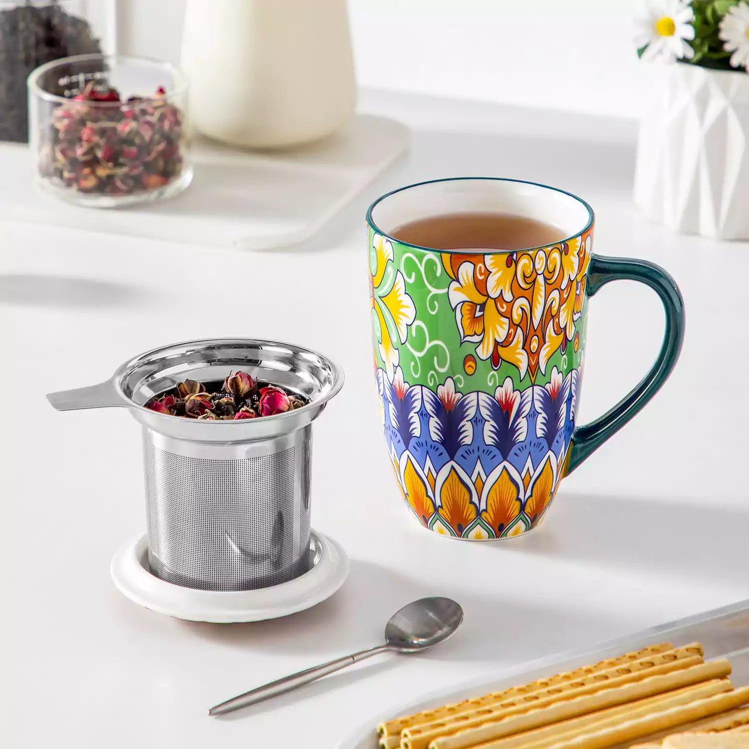Simi tea mug with infuser and lid colorful hunter green boho chic ceramic coffee cup with spoon and loose tea leaves on white background 