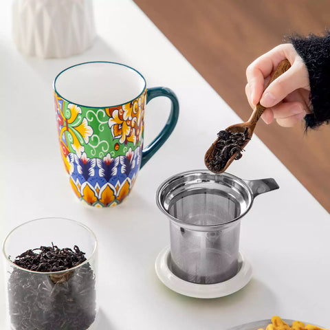 Simi tea mug with infuser and lid colorful hunter green boho chic ceramic coffee cup with spoon and loose tea leaves on white background 