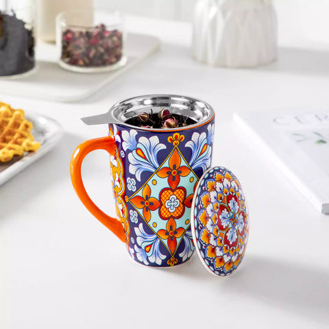 Simi tea mug with infuser and lid colorful bold orange boho chic ceramic coffee cup with spoon and loose tea leaves on white background