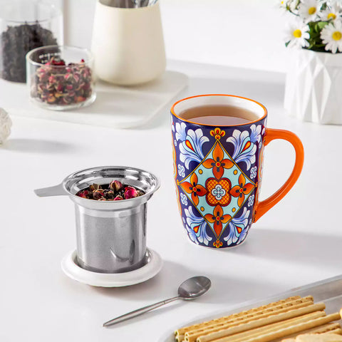Simi tea mug with infuser and lid colorful bold orange boho chic ceramic coffee cup with spoon and loose tea leaves on white background