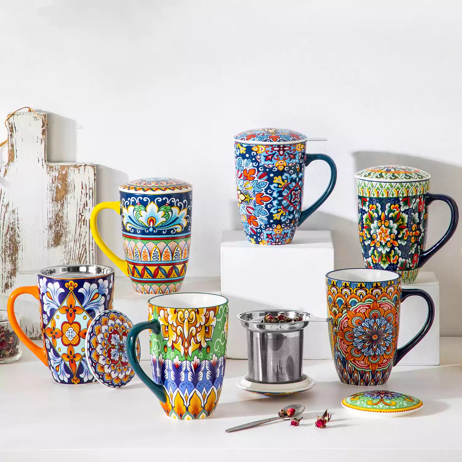 Simi tea mug with infuser and lid colorful bold orange boho chic ceramic coffee cup with spoon and loose tea leaves on white background