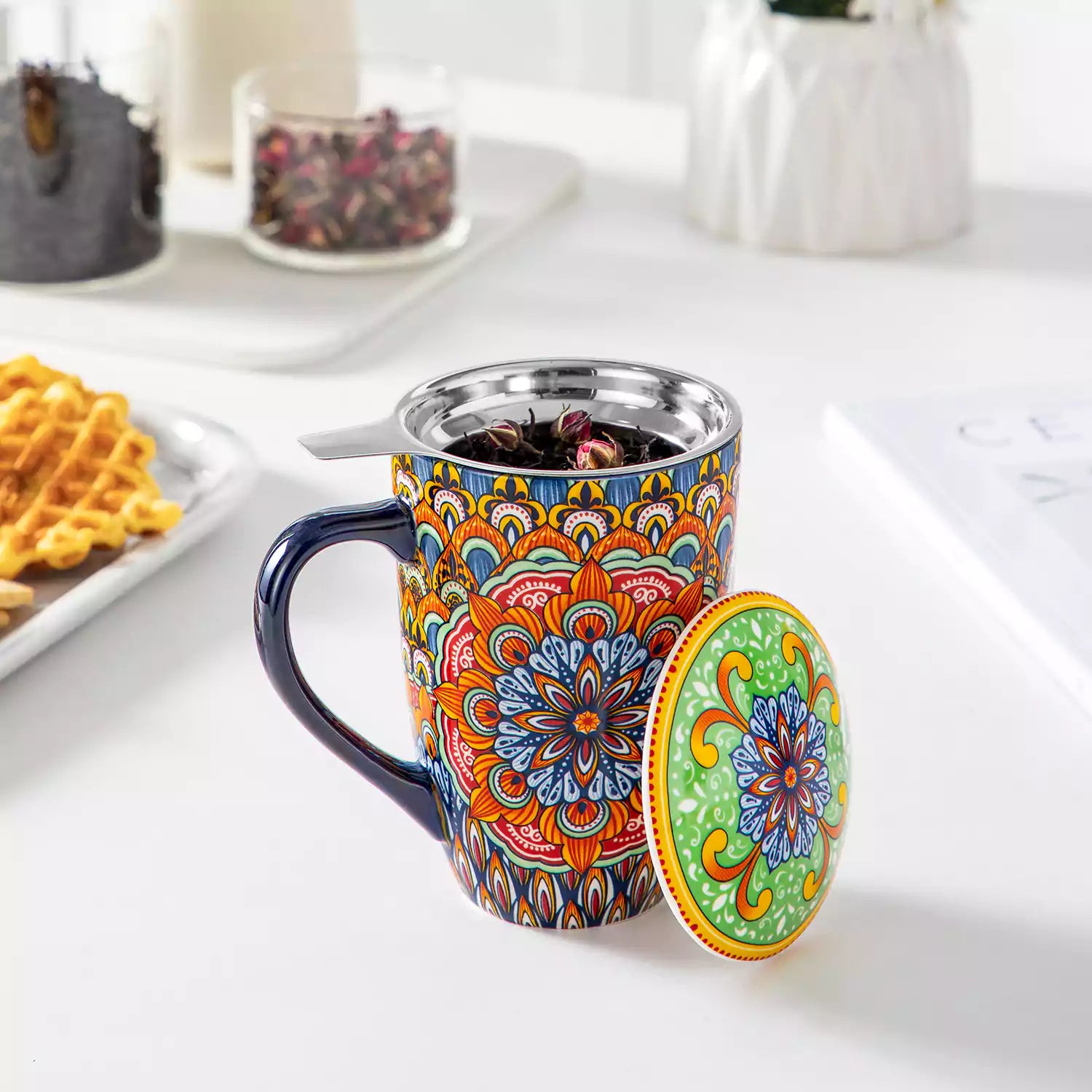 Simi tea mug with infuser and lid colorful forest green boho chic ceramic coffee cup with spoon and loose tea leaves on white background 