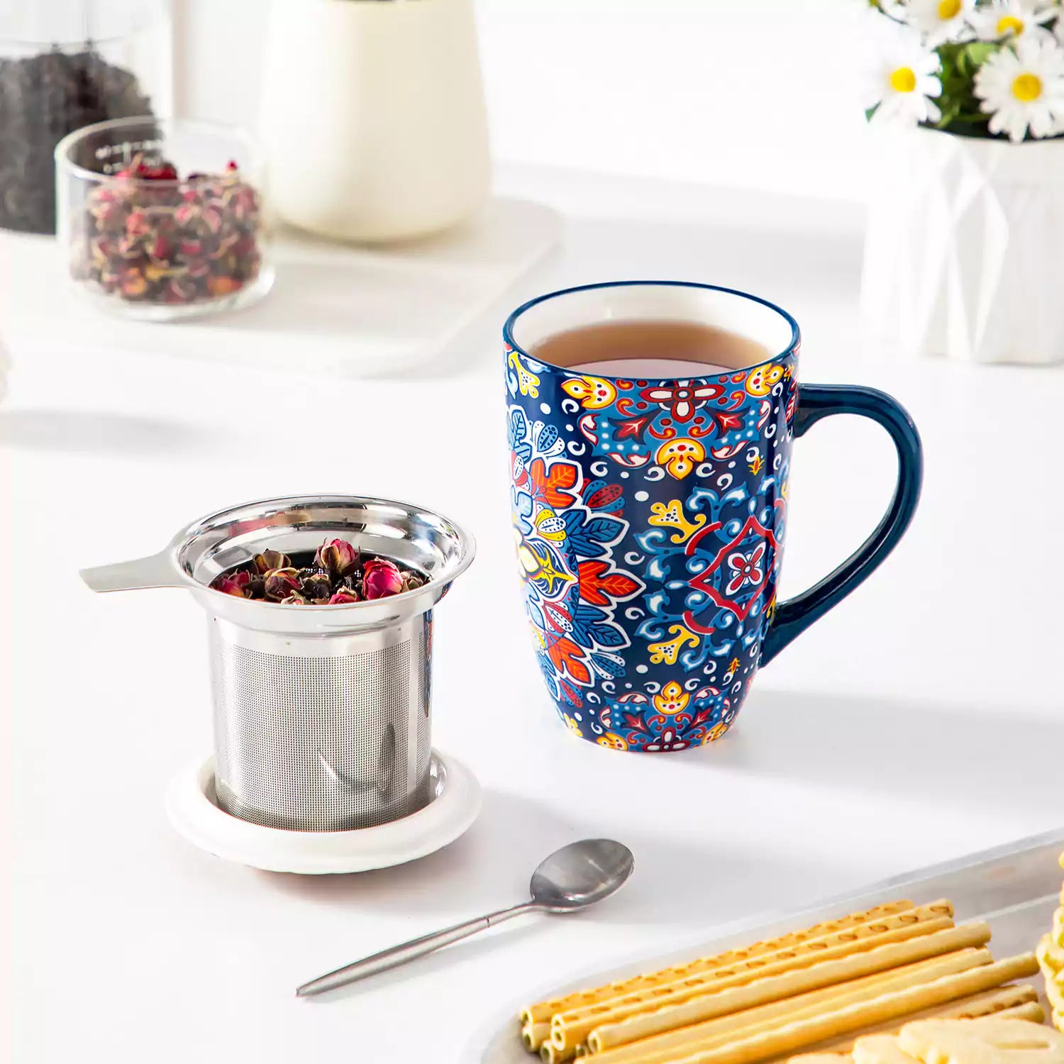 Simi tea mug with infuser and lid colorful navy blue boho chic ceramic coffee cup with spoon and loose tea leaves on white background