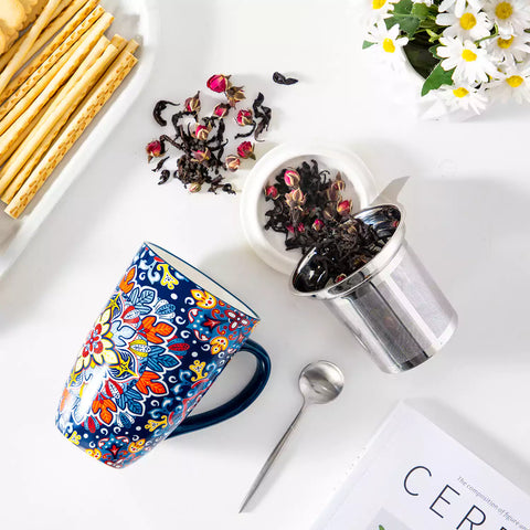 Simi tea mug with infuser and lid colorful navy blue boho chic ceramic coffee cup with spoon and loose tea leaves on white background