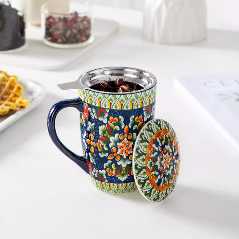 Simi tea mug with infuser and lid colorful midnight blue boho chic ceramic coffee cup with spoon and loose tea leaves on white background