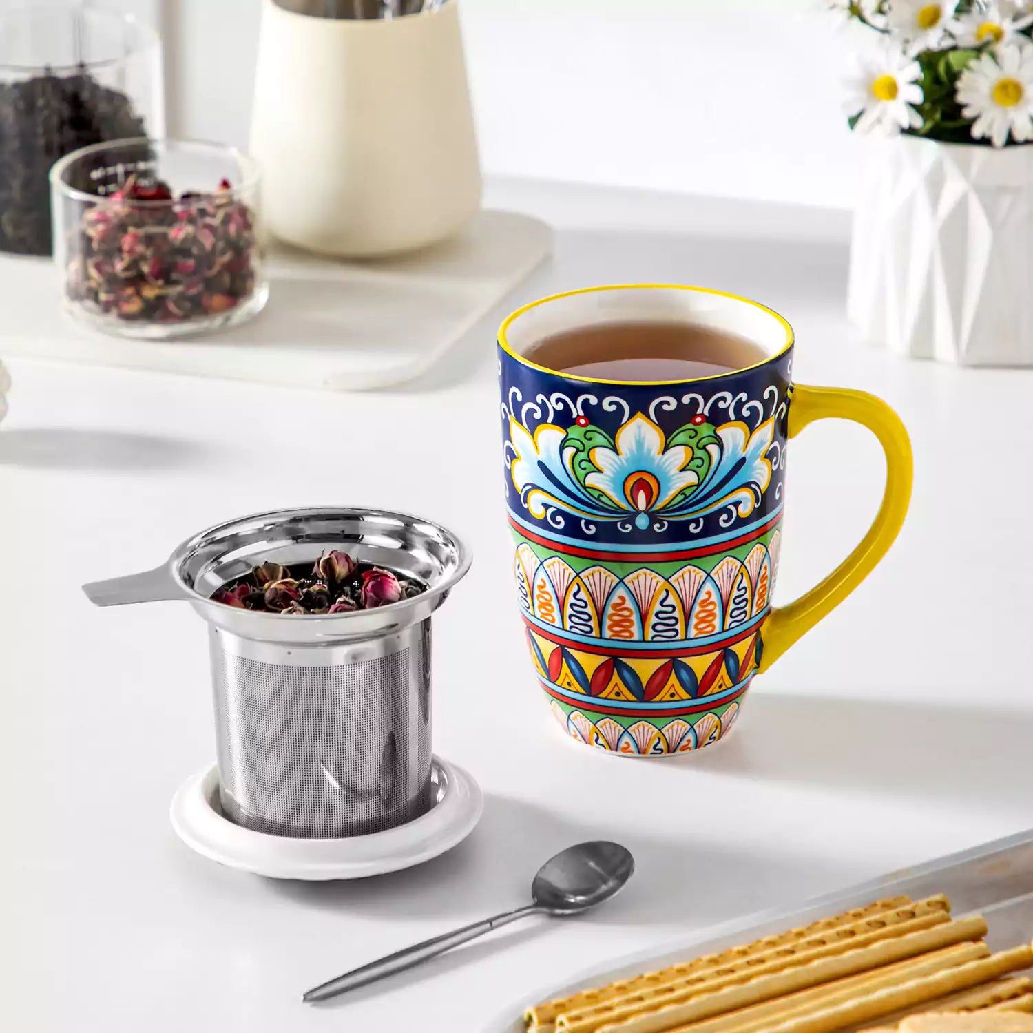 Simi tea mug with infuser and lid colorful golden yellow boho chic ceramic coffee cup with spoon and loose tea leaves on white background