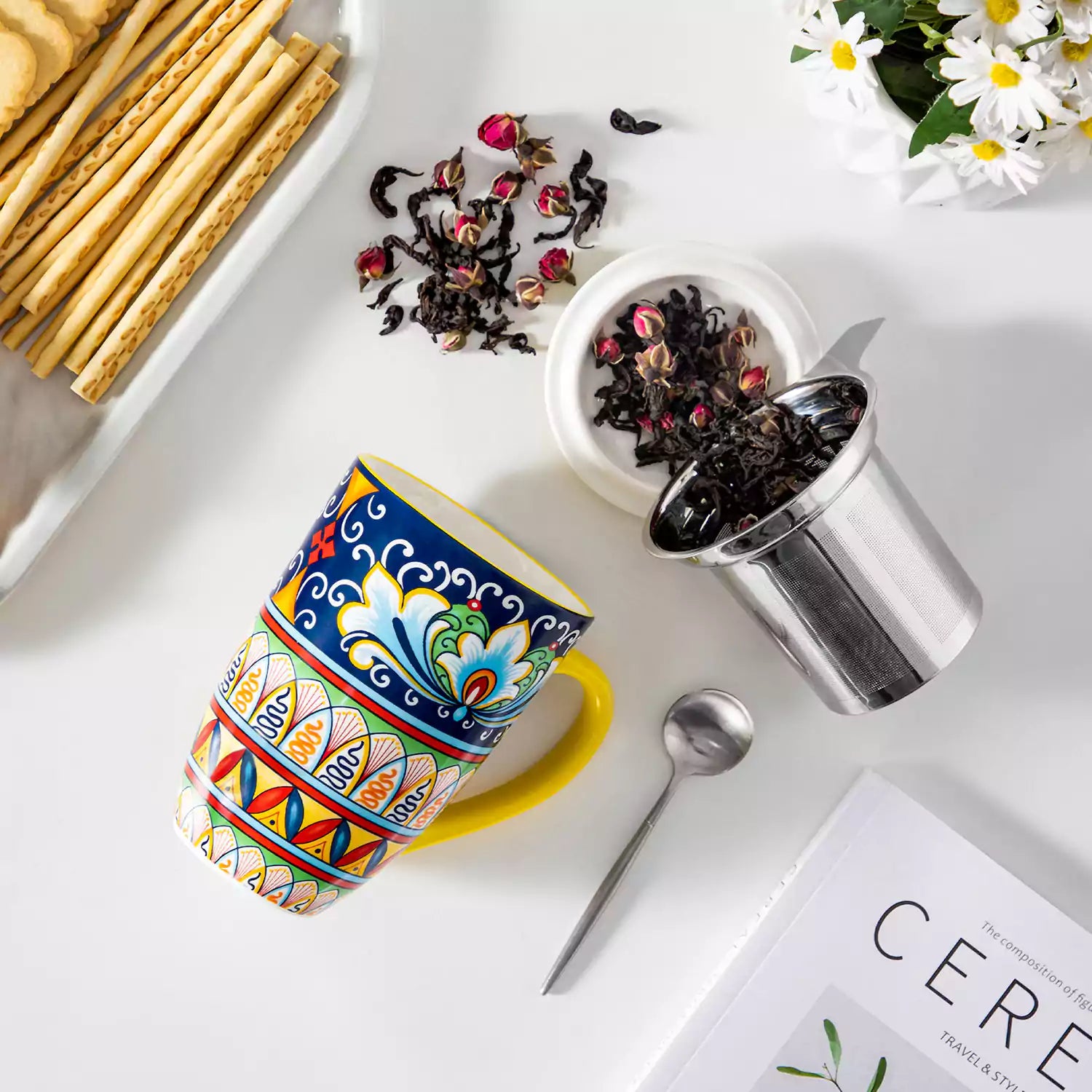 Simi tea mug with infuser and lid colorful golden yellow boho chic ceramic coffee cup with spoon and loose tea leaves on white background