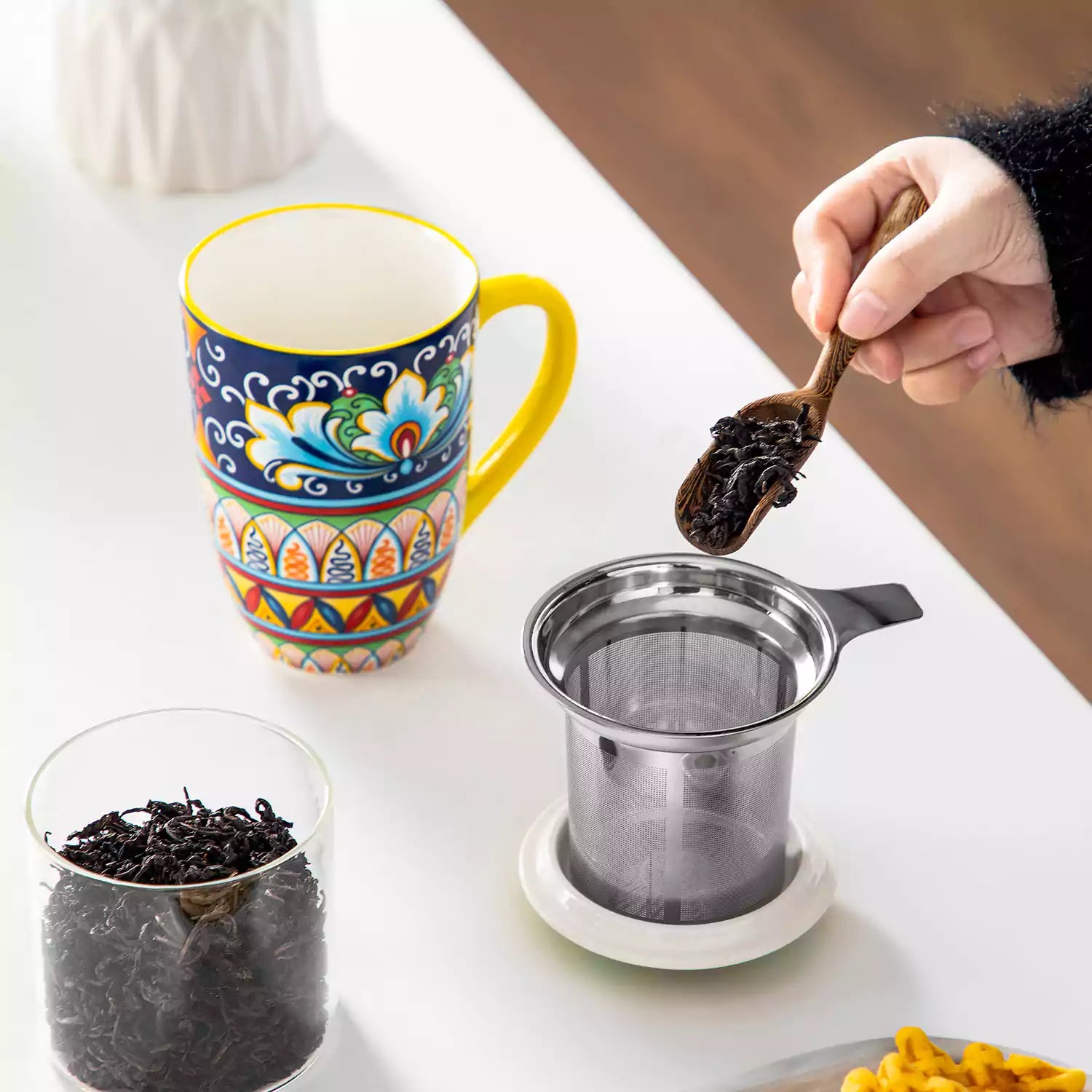 Simi tea mug with infuser and lid colorful golden yellow boho chic ceramic coffee cup with spoon and loose tea leaves on white background