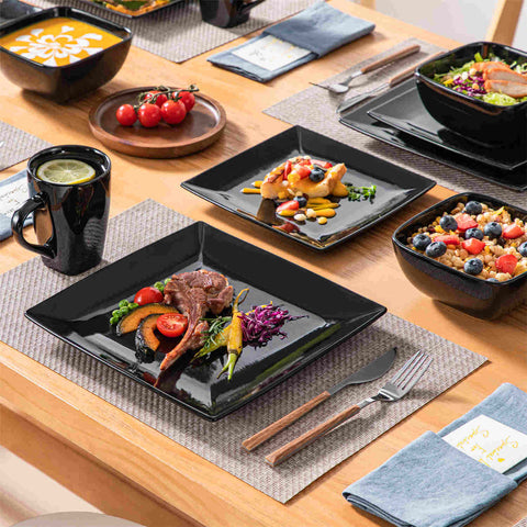 A glossy black 24-piece stoneware dinnerware set from the Soho collection - featuring a sleek square design with plates and mugs for 6 people-vancasso