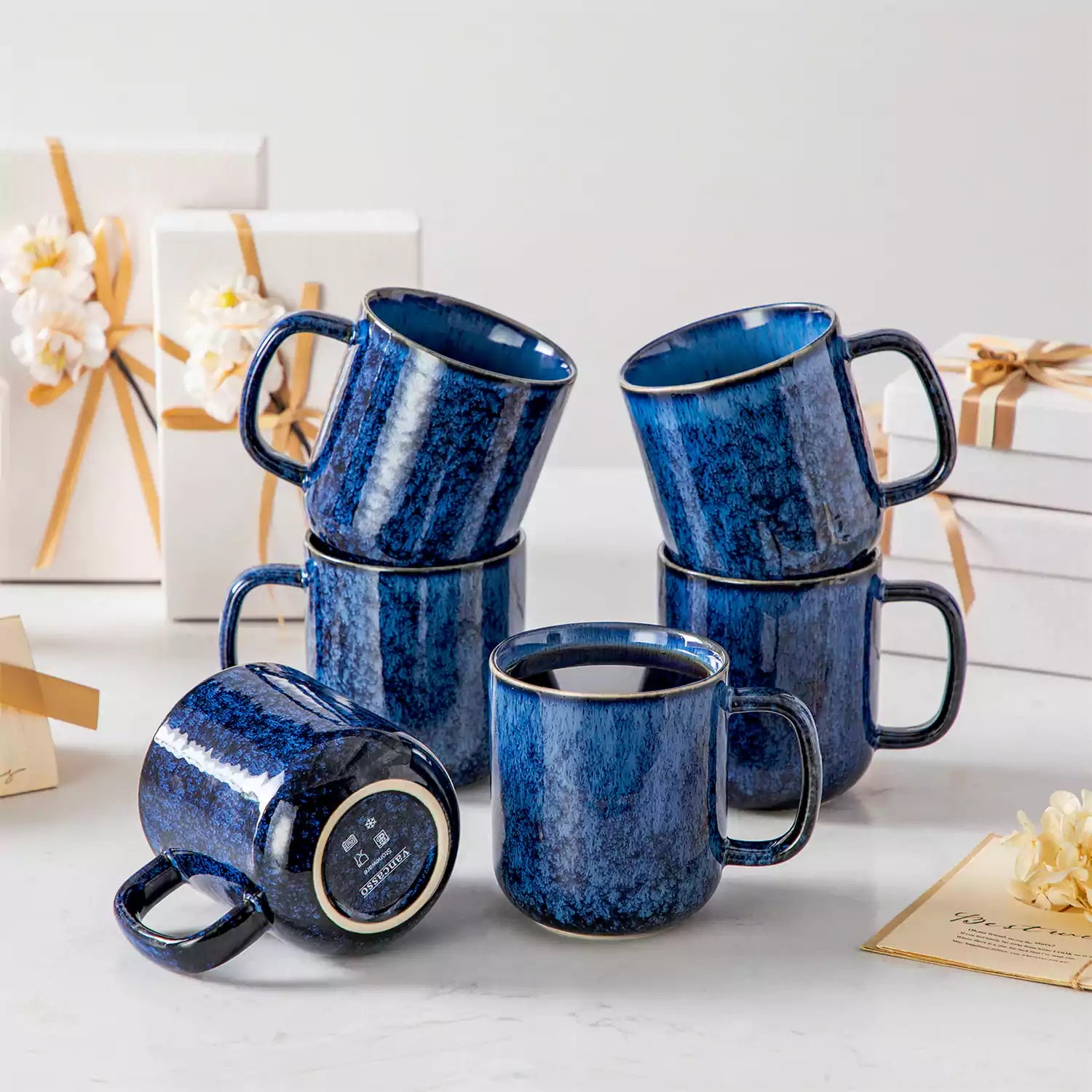 Starry gently curved blue mugs set of 6 displayed on a wooden table with a coffee maker and a plate of pastries