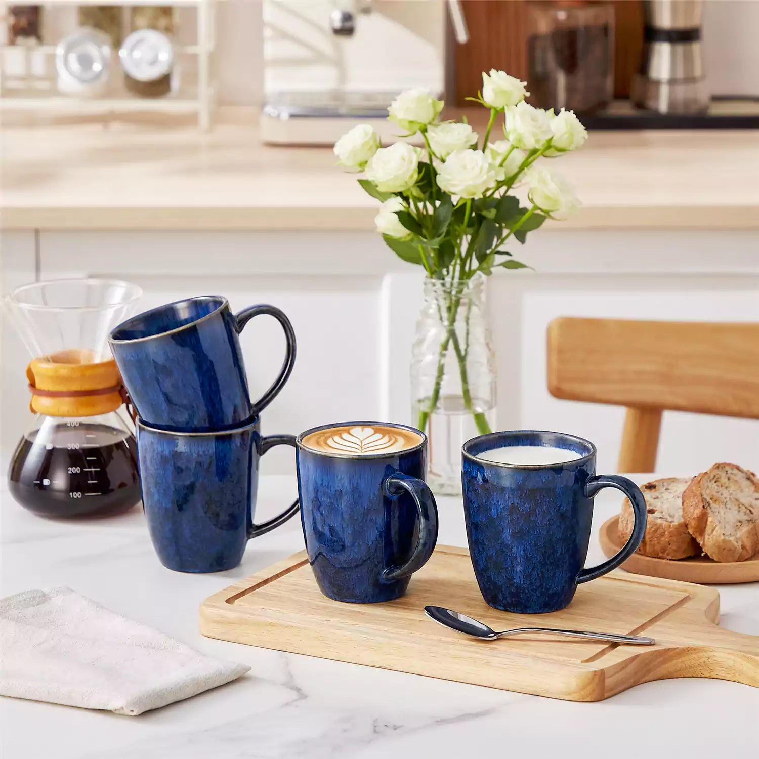 Blue Starry 12oz stoneware mugs set of 4 with reactive glaze finish on a kitchen counter with coffee milk and fresh bread