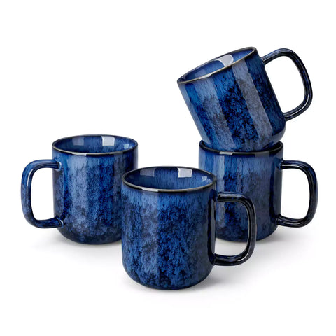 Starry blue 12oz stoneware mugs set of 4 with coffee on wooden table next to coffee maker and fresh bread cozy breakfast scene