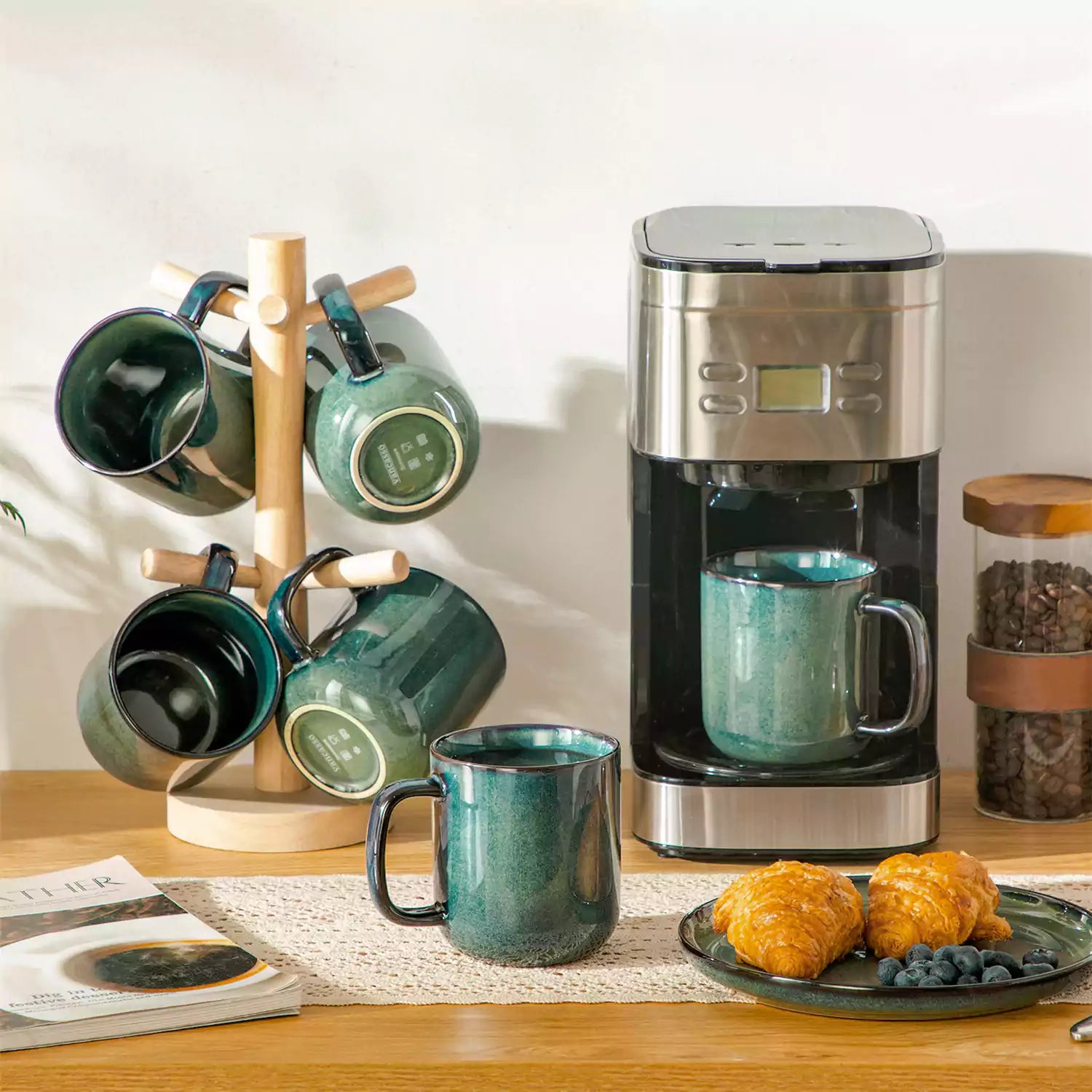 Starry gently curved green mugs set of 6 displayed on a wooden table with a coffee maker and a plate of pastries