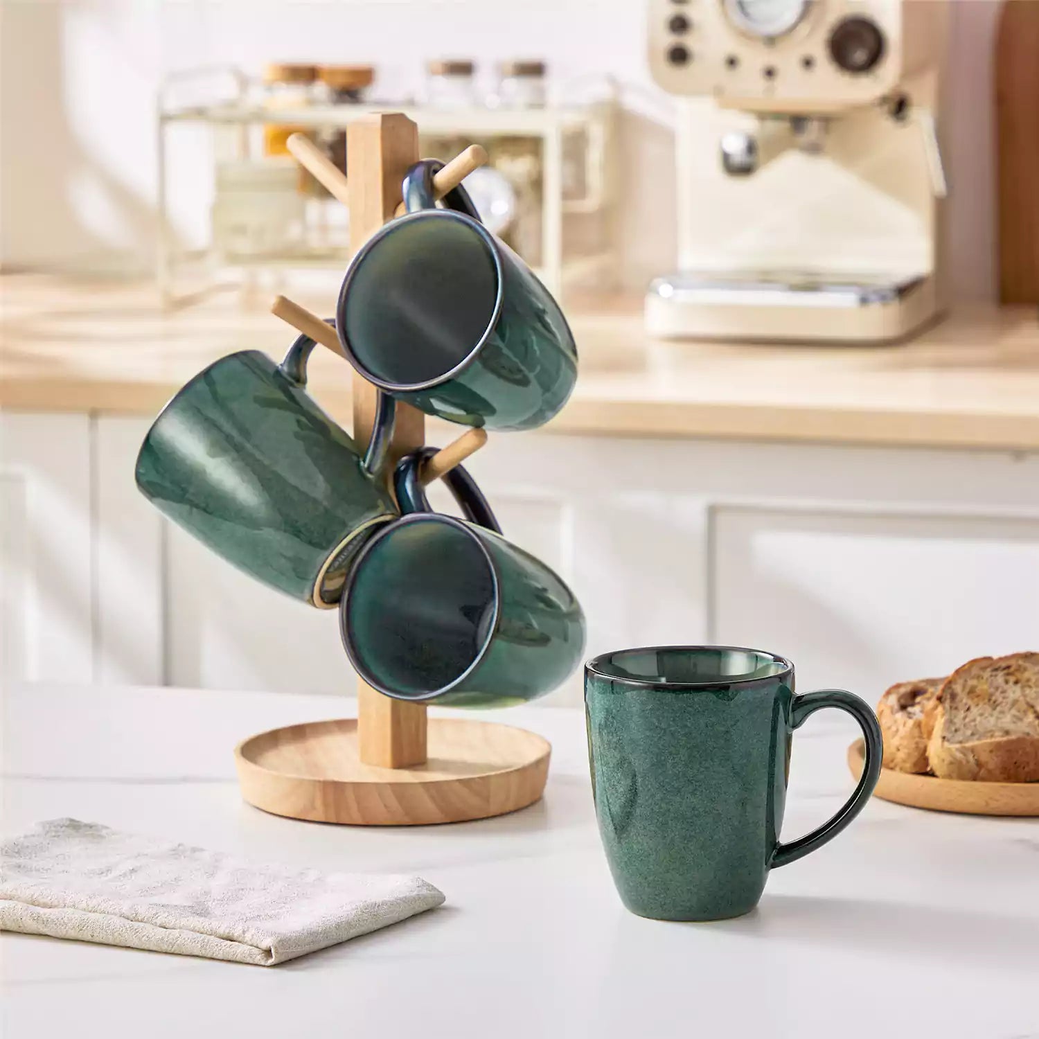 Green Starry 12oz stoneware mugs set of 4 with reactive glaze finish on a kitchen counter with coffee milk and fresh bread