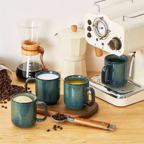 Starry teal 12oz stoneware mugs set of 4 with coffee on wooden table next to coffee maker and fresh bread cozy breakfast scene