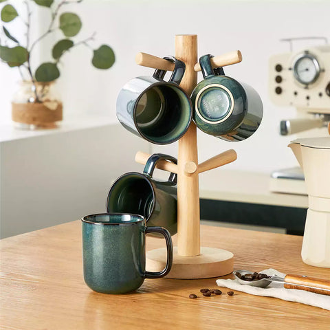 Starry teal 12oz stoneware mugs set of 4 with coffee on wooden table next to coffee maker and fresh bread cozy breakfast scene