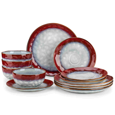Starry 12-piece stoneware dinnerware set in red on a light wooden table - styled with lamb chops - pastries - coffee pot - and lemon water for a cozy farmhouse breakfast scene