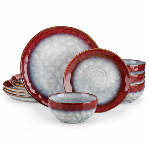 Starry 12-piece stoneware dinnerware set in red on a light wooden table - styled with lamb chops - pastries - coffee pot - and lemon water for a cozy farmhouse breakfast scene